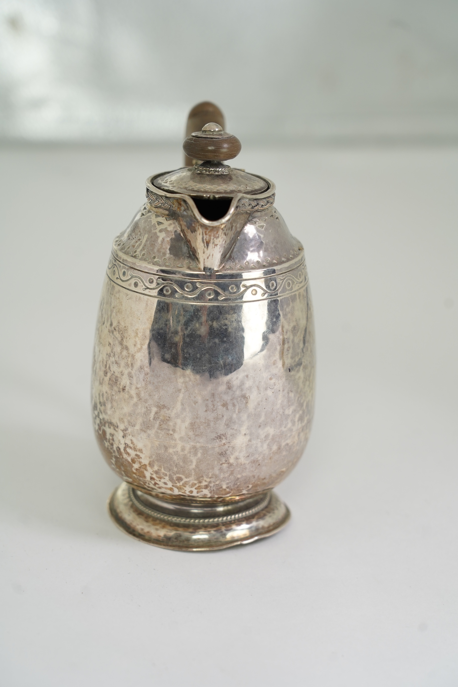 A George V Arts & Crafts silver hot water pot by Liberty & Co